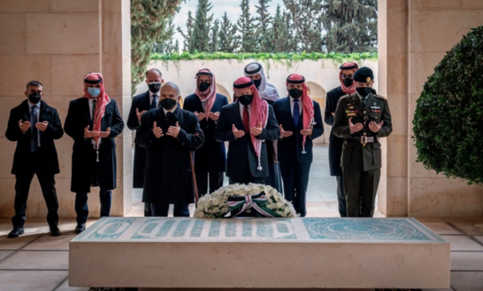 Jordan’s King Abdullah II, centre, Prince Hamzah, second left, and others visit the tomb of the late King Hussein to mark the centenary of the establishment of the Emirate of Transjordan