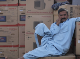 A Pakistani man rests before loading a cargo ship in Dubai