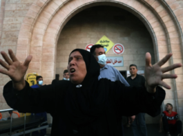 A Palestinian woman reacts outside a hospital in the northern Gaza Strip