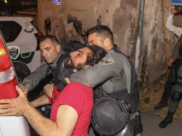 Israeli security forces detain a Palestinian during a confrontation as Palestinian families face eviction in the Sheikh Jarrah neighbourhood of occupied East Jerusalem