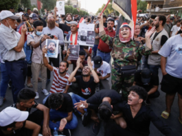 Protesters chanted against 'political parties and traitors' as others tearfully remembered their assassinated comrades [Saba Kareem/Reuters]