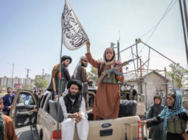 Taliban fighters seen on the back of a vehicle in Kabul, Afghanistan