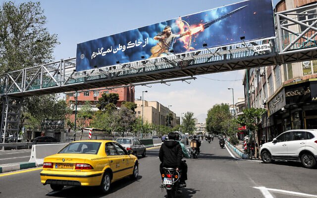 A banner depicting the mythical Persian hero Arash the archer firing a missile from his bow, with text in Persian reading 'I will not abandon my homeland,' hangs on a suspended pedestrian bridge crossing in central Tehran on April 15, 2024. (Atta Kenare/AFP) A banner depicting the mythical Persian hero Arash the archer firing a missile from his bow, with text in Persian reading 'I will not abandon my homeland,' hangs on a suspended pedestrian bridge crossing in central Tehran on April 15, 2024. (Atta Kenare/AFP)