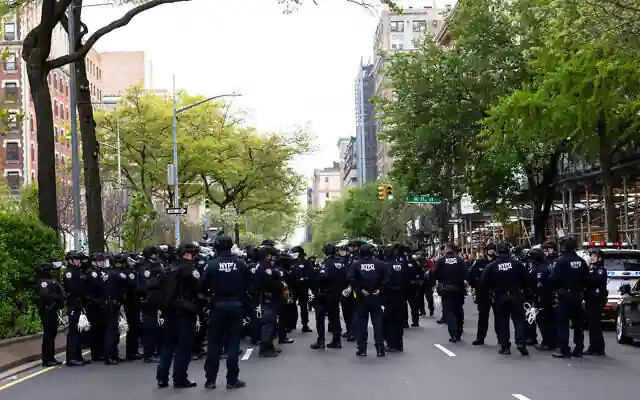 Scores of officers climbed through a window to enter the occupied building, swiftly apprehending multiple protesters who were then taken into custody and removed from campus on buses