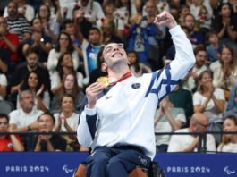 Israeli Paralympian swimmer Ami Dadaon holds his gold medal at the Paris Games on August 30, 2024. (Lilach Weiss Rosenberg)