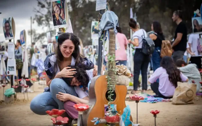 Friends and family of the victims of the Nova music festival massacre gather at the site of the massacre in southern Israel one year after the brutal assault, October 7, 2024. (Yonatan Sindel/Flash90) Friends and family of the victims of the Nova music festival massacre gather at the site of the massacre in southern Israel one year after the brutal assault, October 7, 2024. (Yonatan Sindel/Flash90)