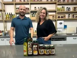 Oriana Tubul (R), CEO of the Yad Mordechai honey and olive oil processing factory, and Ido Dvir, the company’s manager of agricultural raw materials, at Kibbutz Yad Mordechai, southern Israel, September 1, 2024. (Sue Surkes/Times of Israel)