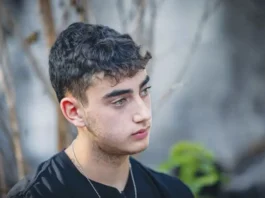 RELEASED HOSTAGE Ofir Engel, 18, appears before the foreign media at a news conference in Kibbutz Be’eri to tell of his ordeal. (photo credit: YONATAN SINDEL/FLASH90)