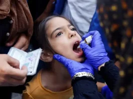 A Palestinian girl is vaccinated against polio, amid the Israel-Hamas conflict, in Khan Younis in the southern Gaza Strip, September 5, 2024. (photo credit: REUTERS/Mohammed Salem TPX IMAGES OF THE DAY)
