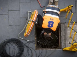 An employee for the Bezeq telecommunications company works on underground infrastructure in Jerusalem (photo credit: NATI SHOHAT/FLASH90)