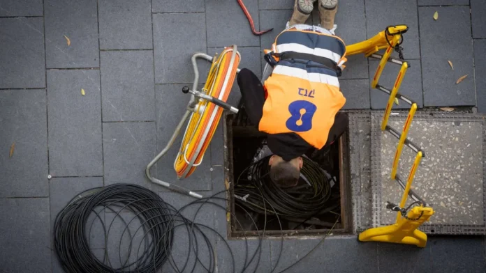 An employee for the Bezeq telecommunications company works on underground infrastructure in Jerusalem (photo credit: NATI SHOHAT/FLASH90) An employee for the Bezeq telecommunications company works on underground infrastructure in Jerusalem (photo credit: NATI SHOHAT/FLASH90)