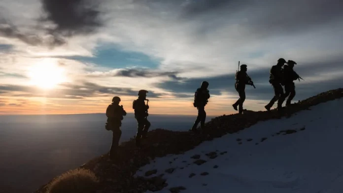 Israeli activists lay a symbolic cornerstone in Neveh Habashan, southern Syria, before being detained and returned by IDF forces