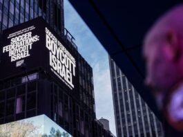 A Times Square billboard accuses Israel of “genocide” as activists launch the #GameOverIsrael soccer boycott campaign on September 16, 2025