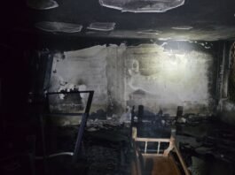 Firefighters evacuate residents from a burning Beersheba apartment building during a series of suspected arson attacks overnight