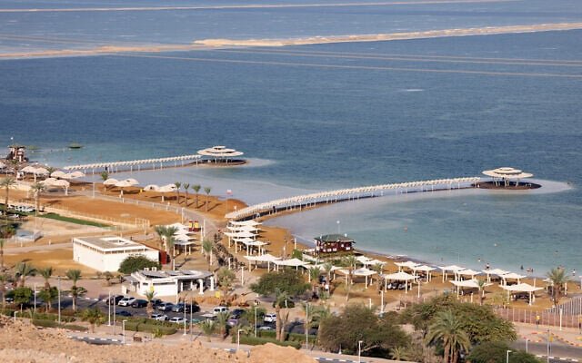 Hikers view a water-filled sinkhole along the Dead Sea shore near Ein Gedi during a winter excursion Hikers view a water-filled sinkhole along the Dead Sea shore near Ein Gedi during a winter excursion