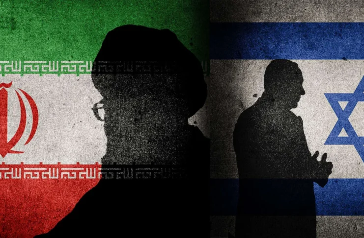 An Israeli man walks past graffiti of Iran’s Supreme Leader in Tel Aviv following the recent Iran-Israel conflict