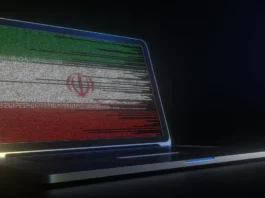 Illustration shows a cyber hacker alongside the Iranian flag, symbolizing state-linked digital threats and escalating cyber warfare tactics