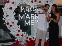 Former hostages Matan Zangauker and Ilana Gritzwesky smile beside a proposal sign, symbolising love and survival after Gaza captivity