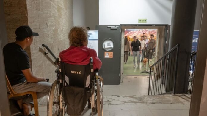 Residents gather in an underground parking garage in Tel Aviv after missile sirens, highlighting the lack of proper bomb shelters Residents gather in an underground parking garage in Tel Aviv after missile sirens, highlighting the lack of proper bomb shelters